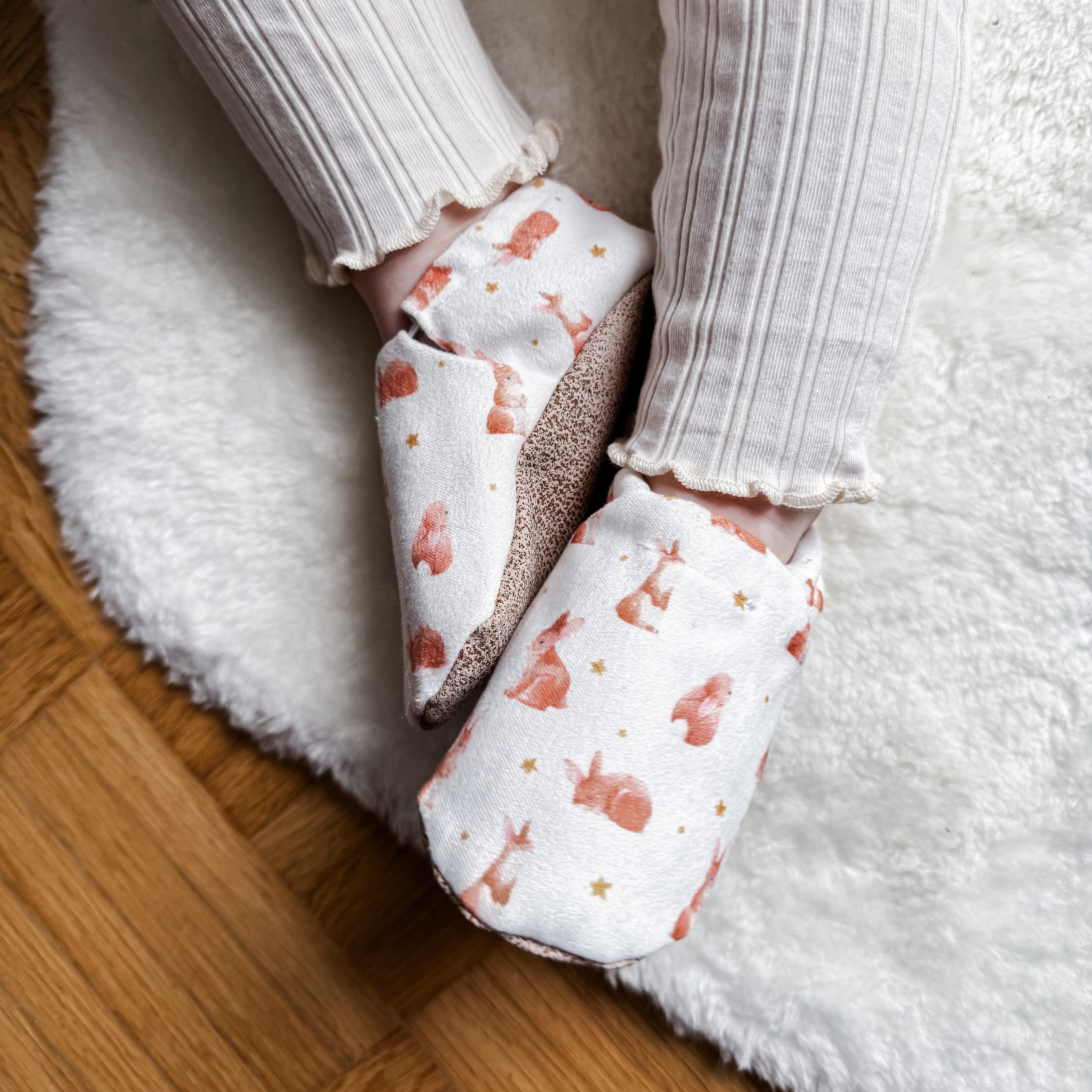 Cute bunnies in peach for first baby steps.