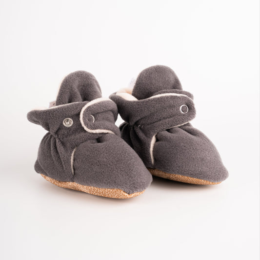Comfortable and breathable baby booties in gray with non-slip soles for safe adventures. side view.